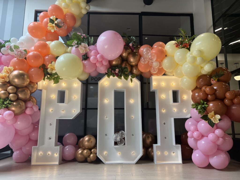 balloon arch and large sign at event