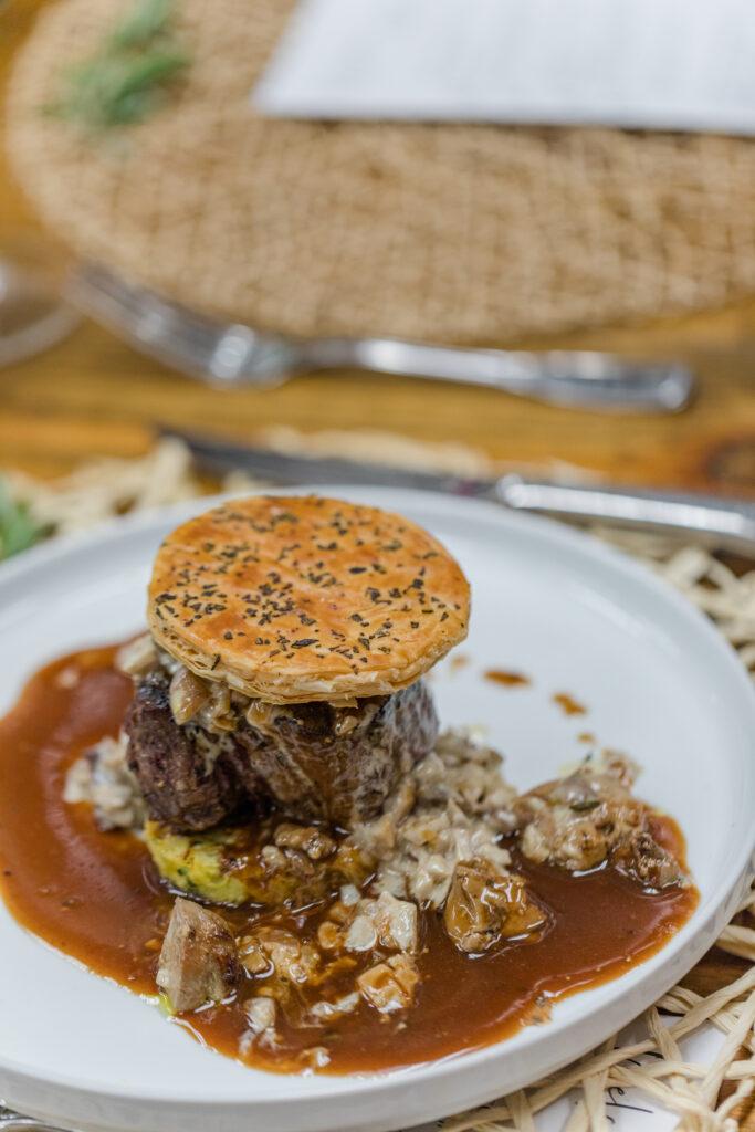 Spaghetti squash souffle, wagyu filet mignon ,Foie Gras, ragout of mushroom Sauce Beau manière served under a rosemary crisp pastry lid