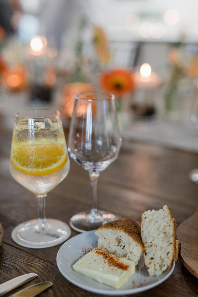 bread served at table with butter and water glass