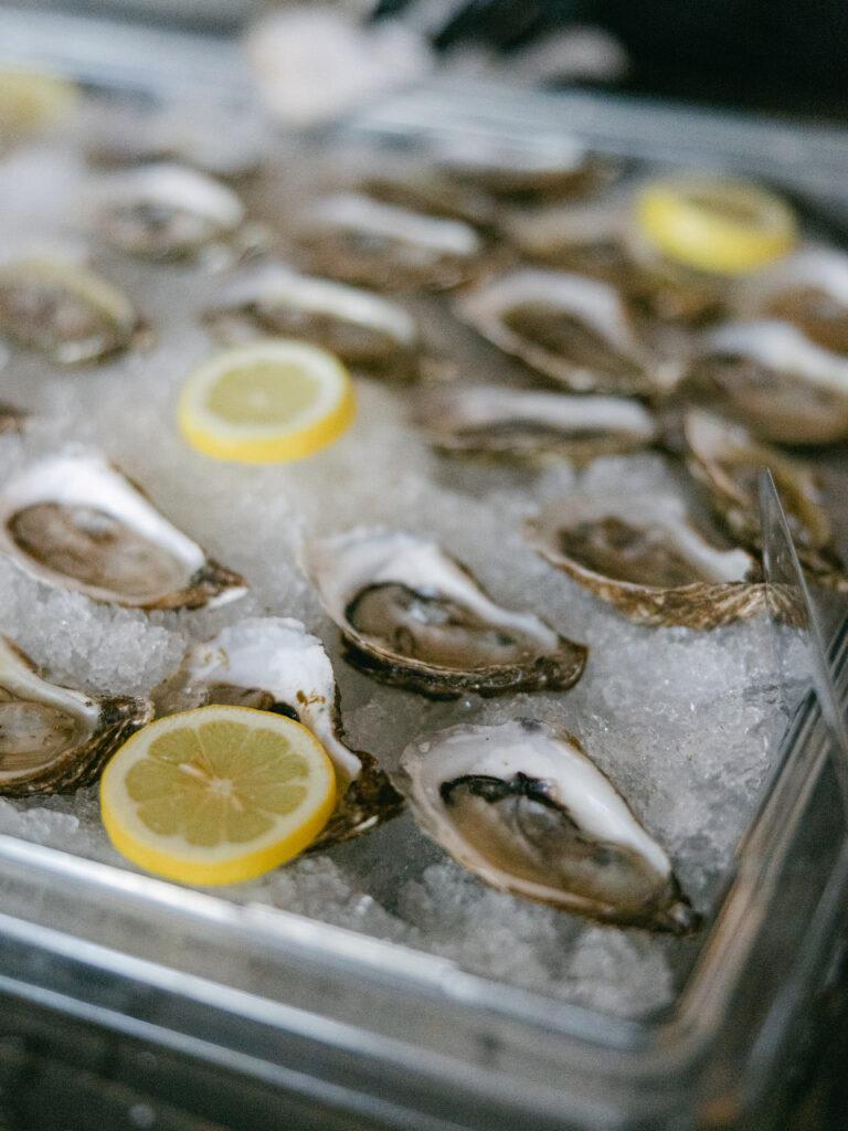 oysters on ice tray with lemon