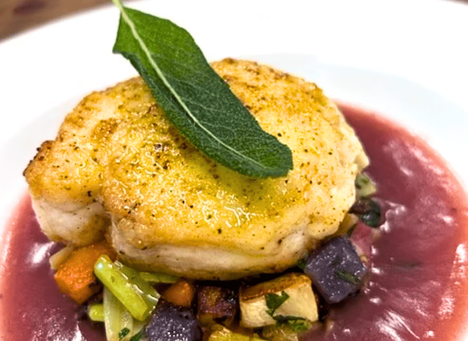 lemon-crusted halibut on roasted root vegetables in a red wine beurre blanc