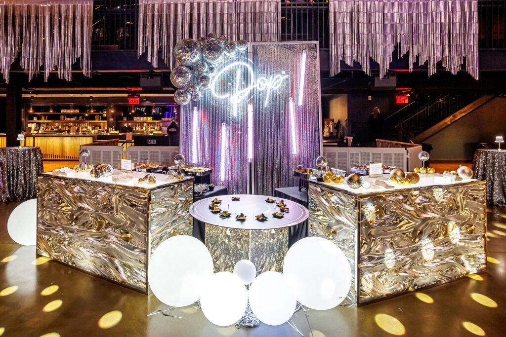 photo of a buffet with statement lighting and a neon sign 