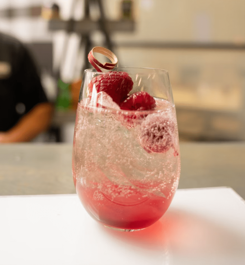 raspberry spritz featuring prosecco, raspberry simple syrup, and Cointreau