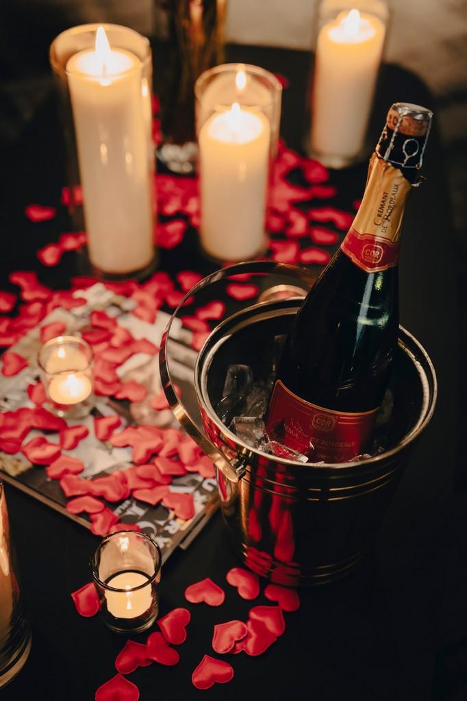Romantic scene with rose petals and champagne