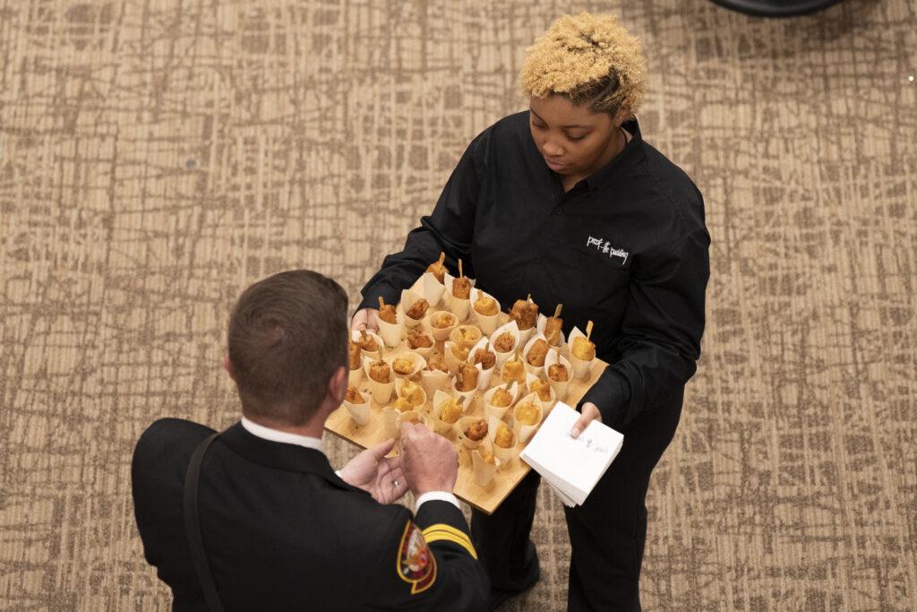 Pop staff serving French Toast Shooters with Turkey Bacon