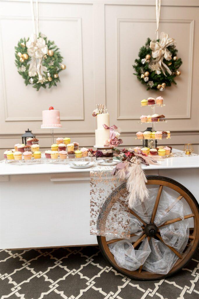 Dessert bar with wedding cake and cupcakes