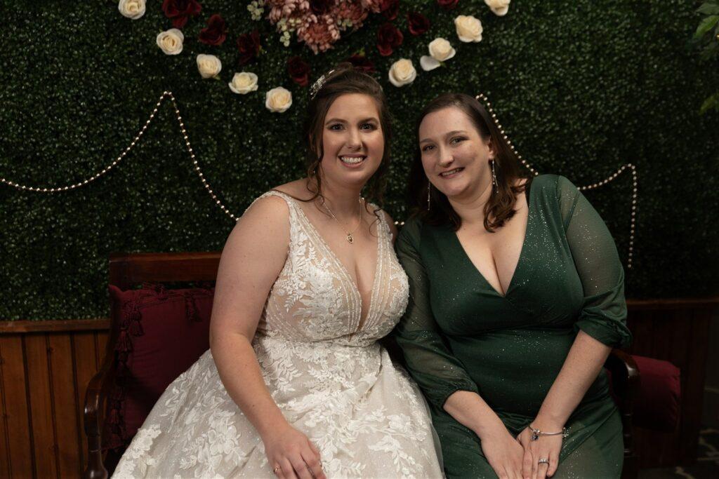 Bride posing with her friend at her wedding