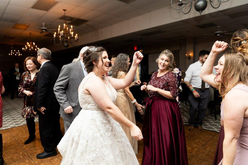 Bride dancing with familhy