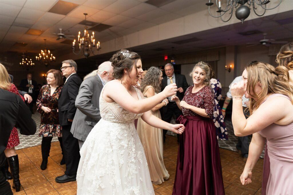 Bride dancing with loved ones at her wedding