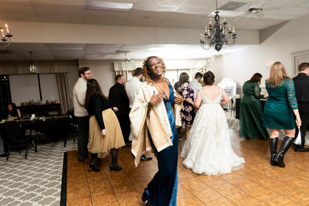 Happy wedding guest dancing in Carriage Room